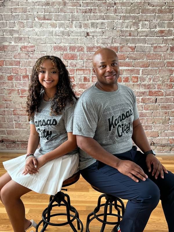 Lovie and his daughter Bella in Kansas City shirts